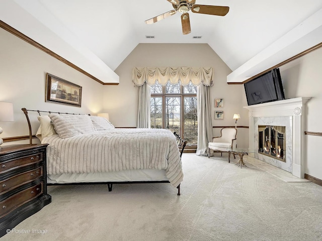 carpeted bedroom with a high end fireplace, visible vents, ceiling fan, and lofted ceiling