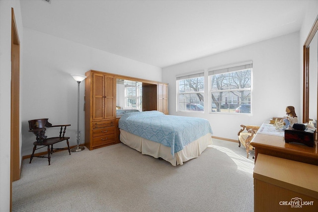 bedroom featuring baseboards and light carpet