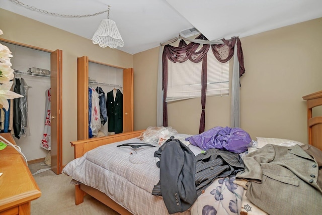 bedroom featuring two closets and carpet