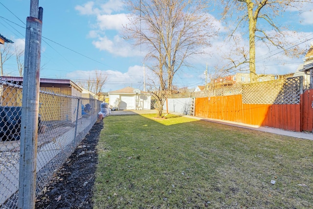 view of yard featuring an outdoor structure and a fenced backyard