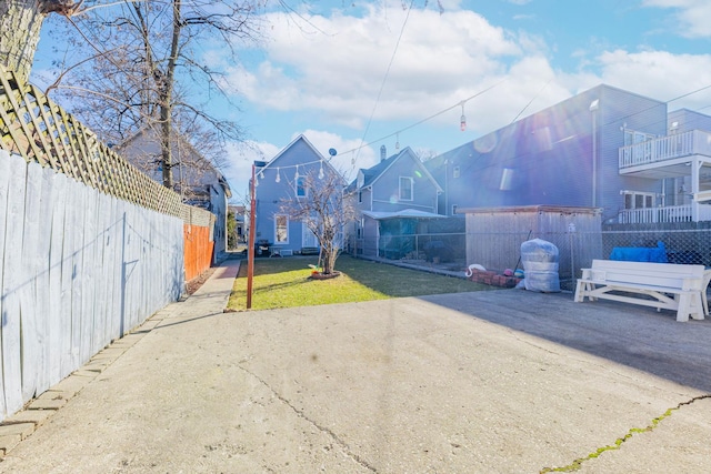 view of yard featuring fence and a patio area