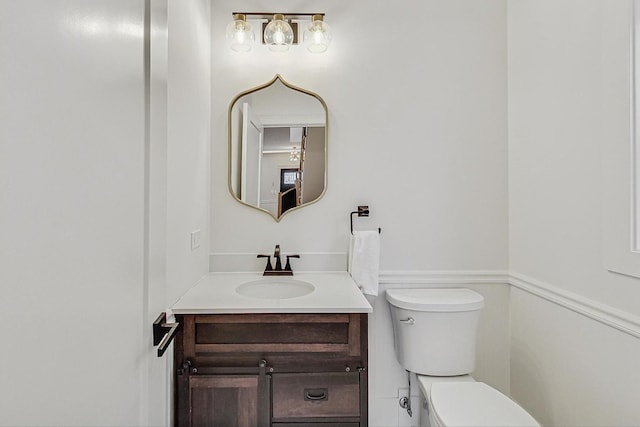 bathroom featuring toilet and vanity