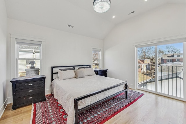 bedroom featuring visible vents, access to outside, light wood finished floors, baseboards, and vaulted ceiling