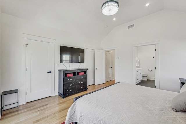 bedroom with wood finished floors, visible vents, high vaulted ceiling, ensuite bath, and recessed lighting