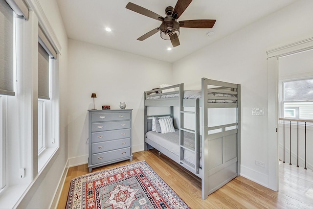 bedroom featuring recessed lighting, baseboards, light wood finished floors, and ceiling fan