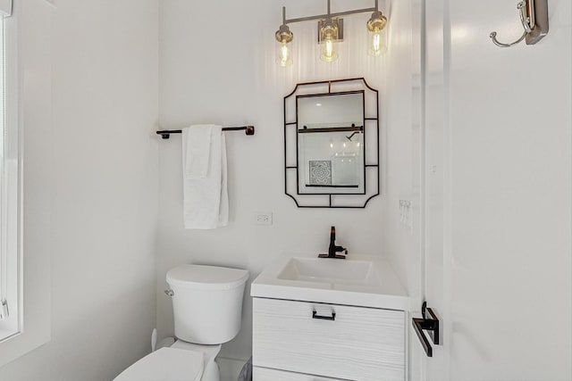 bathroom featuring toilet and vanity