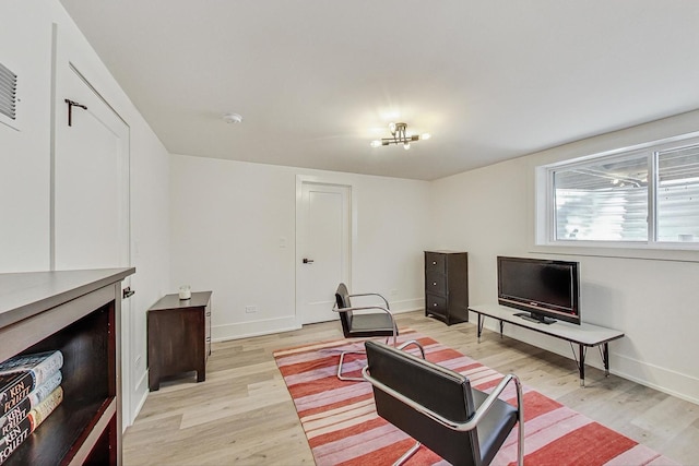 living room featuring baseboards and light wood finished floors