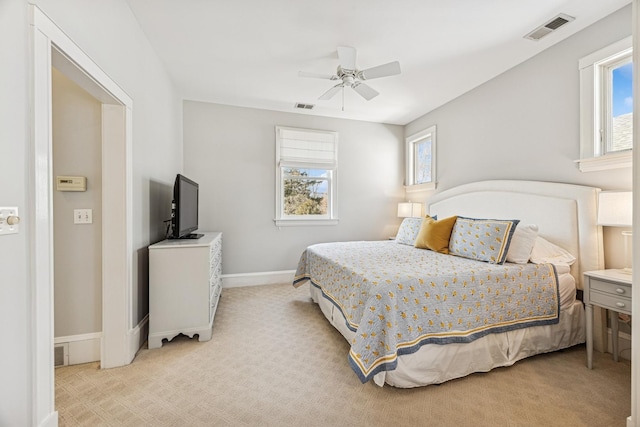 bedroom featuring visible vents, baseboards, and light colored carpet