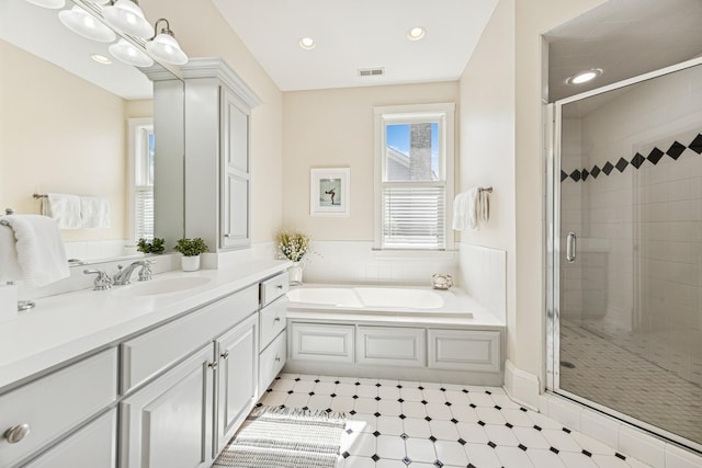 bathroom with vanity, visible vents, recessed lighting, a shower stall, and a garden tub