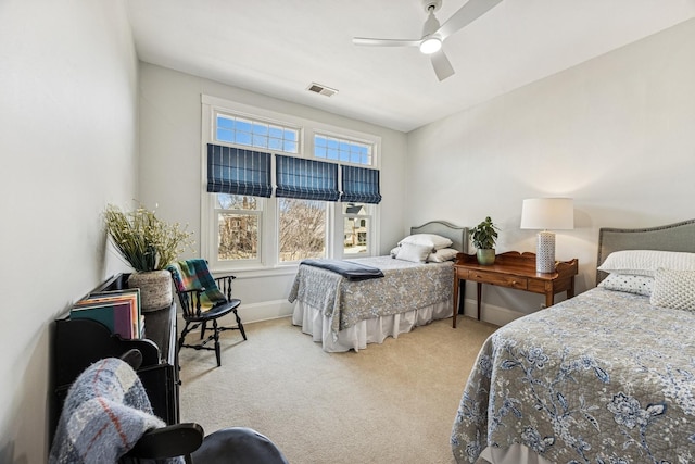 bedroom with visible vents, carpet floors, baseboards, and ceiling fan