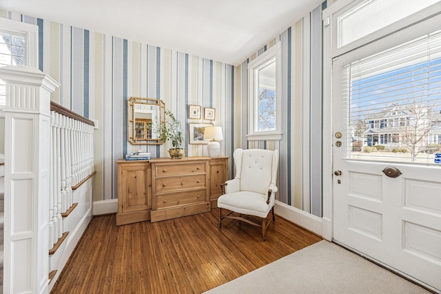 sitting room with baseboards, wood finished floors, and wallpapered walls