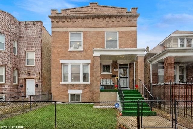 view of front of property featuring a fenced front yard, brick siding, a front yard, and a gate