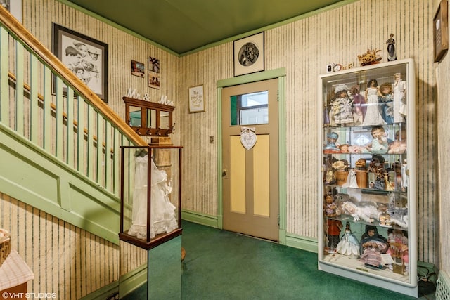 foyer entrance featuring carpet flooring, stairway, wallpapered walls, and baseboards