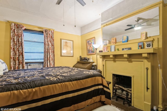 bedroom featuring cooling unit and a fireplace