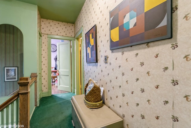 corridor with wallpapered walls, an upstairs landing, carpet, and baseboards