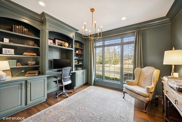 office featuring a notable chandelier, crown molding, dark wood-type flooring, and built in desk