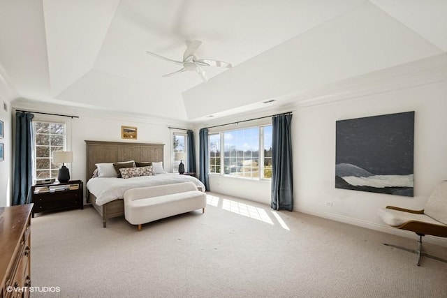 carpeted bedroom featuring ceiling fan, baseboards, and a tray ceiling