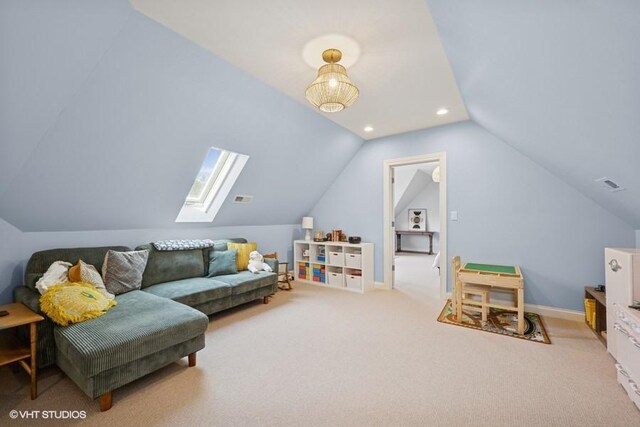 interior space featuring visible vents, recessed lighting, vaulted ceiling with skylight, carpet flooring, and baseboards