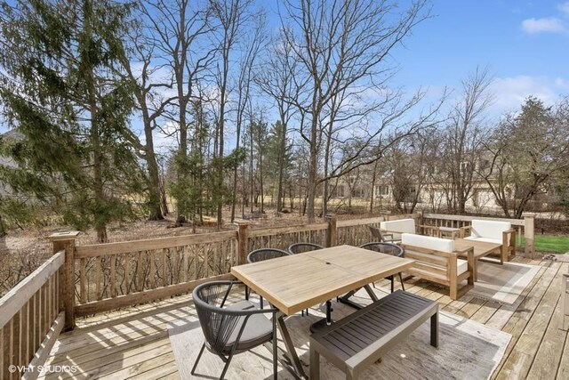 wooden deck with outdoor dining space