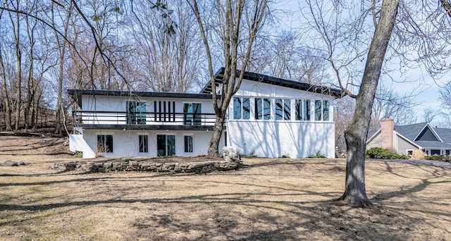 rear view of house featuring a wooden deck