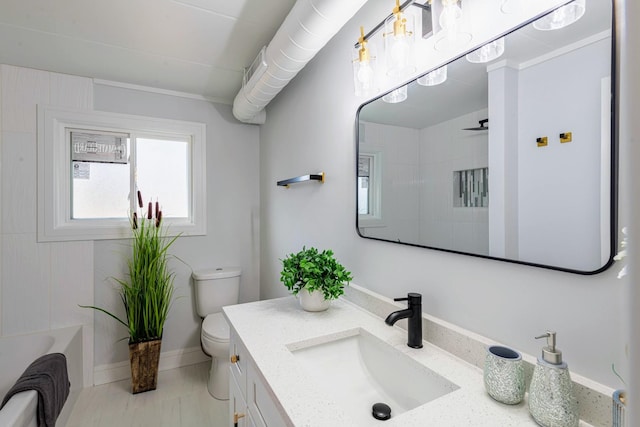 full bath featuring vanity, toilet, and baseboards