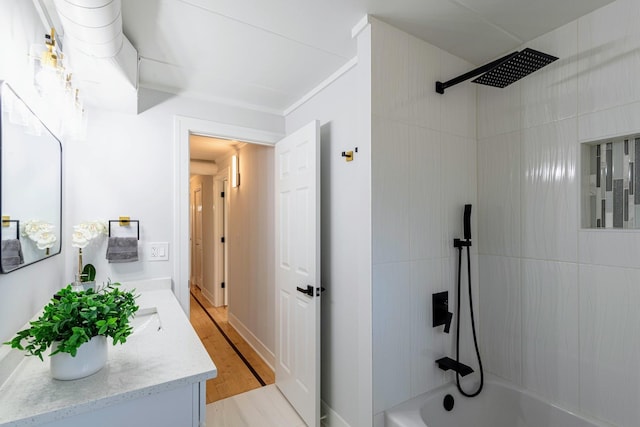 full bathroom featuring double vanity, tub / shower combination, and wood finished floors