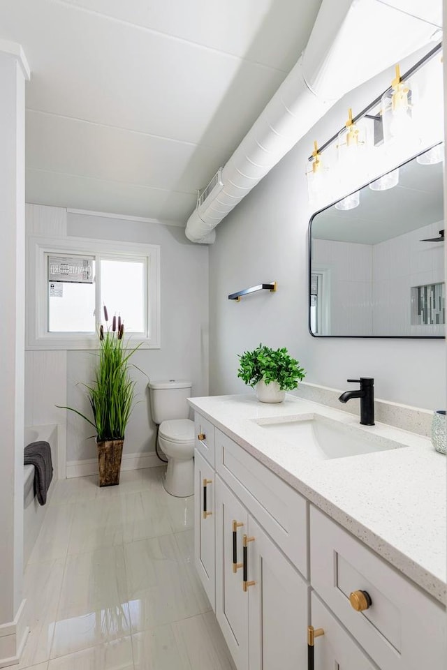 bathroom featuring visible vents, baseboards, toilet, and vanity