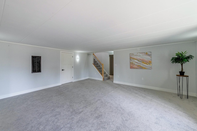 unfurnished living room with stairway, carpet floors, and baseboards