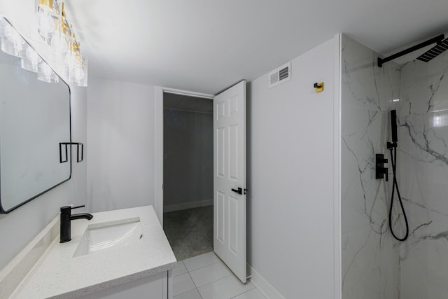 bathroom featuring a marble finish shower, visible vents, vanity, and baseboards