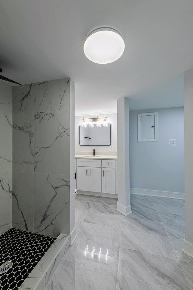 full bath featuring marble finish floor, electric panel, a marble finish shower, baseboards, and vanity