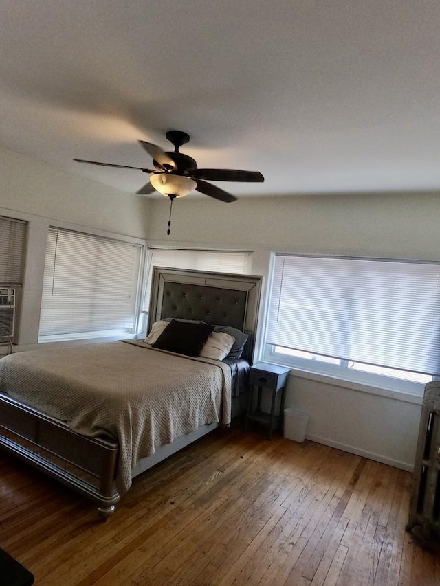 unfurnished bedroom featuring wood-type flooring and ceiling fan