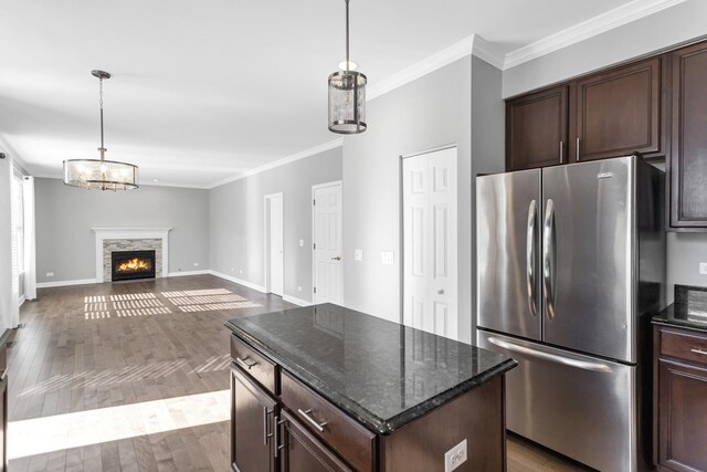 kitchen with crown molding, dark brown cabinets, dark wood-style flooring, and freestanding refrigerator