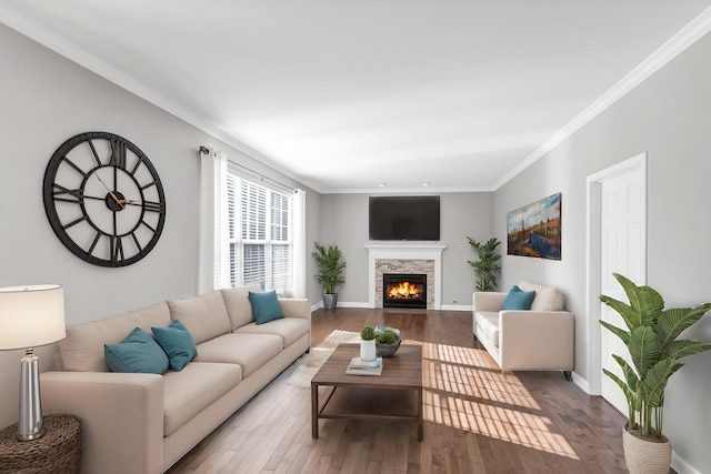 living room with wood finished floors, baseboards, and ornamental molding