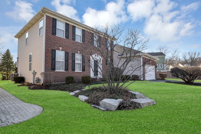 view of front of property featuring a front yard, cooling unit, driveway, a garage, and brick siding