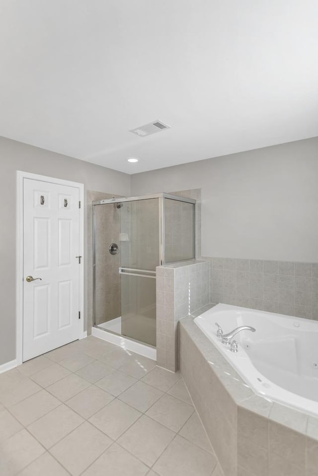 bathroom featuring tile patterned floors, visible vents, a shower stall, and a tub with jets