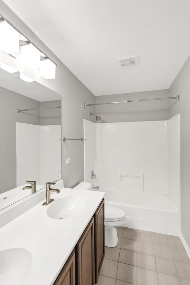 full bath featuring visible vents, toilet, a sink,  shower combination, and tile patterned flooring