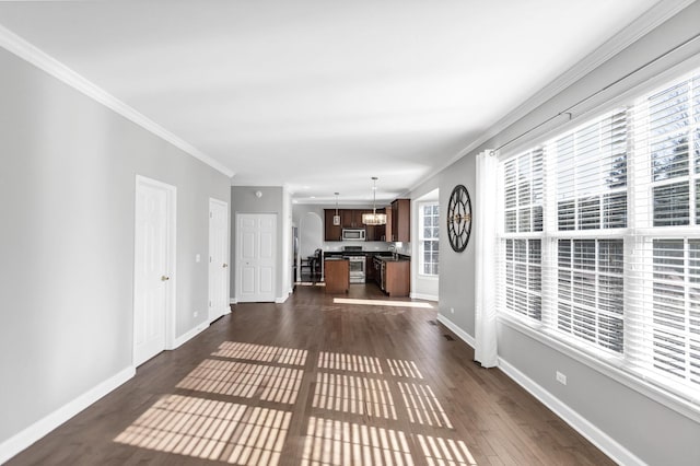 hall with a sink, baseboards, dark wood-style flooring, and crown molding