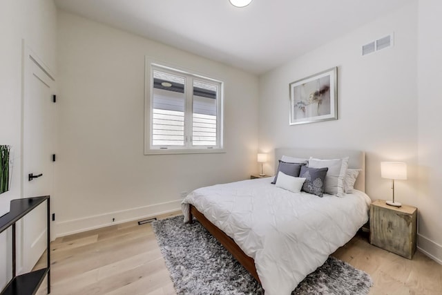 bedroom with visible vents, baseboards, and light wood-style floors