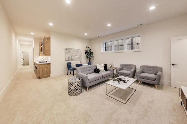 living room featuring recessed lighting, light colored carpet, visible vents, and baseboards