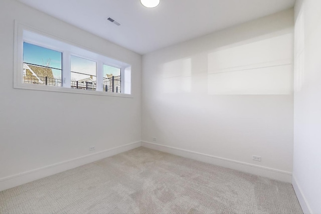 unfurnished room featuring visible vents, carpet flooring, and baseboards