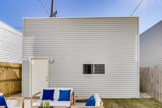 back of property with a patio area and a fenced backyard