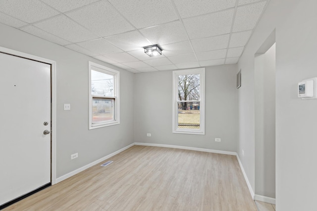 interior space with visible vents, a healthy amount of sunlight, baseboards, and wood finished floors