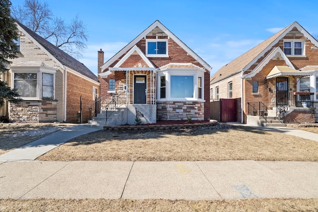 view of front of property featuring brick siding and stone siding