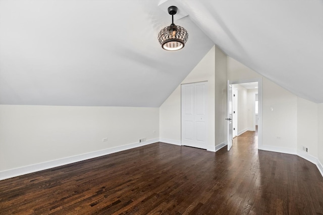 bonus room featuring vaulted ceiling, dark wood-style floors, baseboards, and visible vents