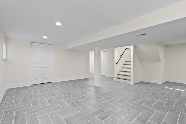 finished below grade area featuring visible vents, recessed lighting, stairs, and baseboards