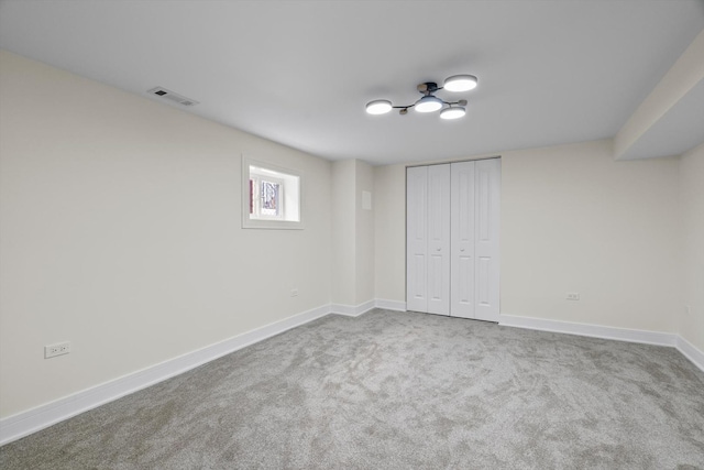 unfurnished bedroom featuring visible vents, carpet floors, baseboards, and a closet