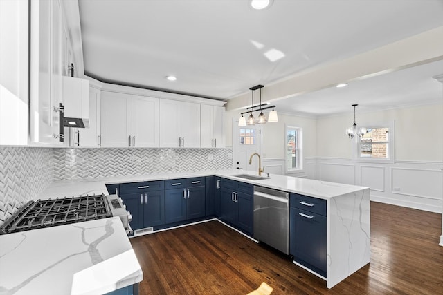 kitchen with white cabinetry, a peninsula, blue cabinetry, a sink, and stainless steel dishwasher