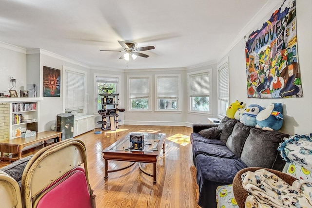 living room with ceiling fan, wood finished floors, baseboards, and ornamental molding