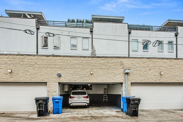 view of property featuring an attached garage and driveway