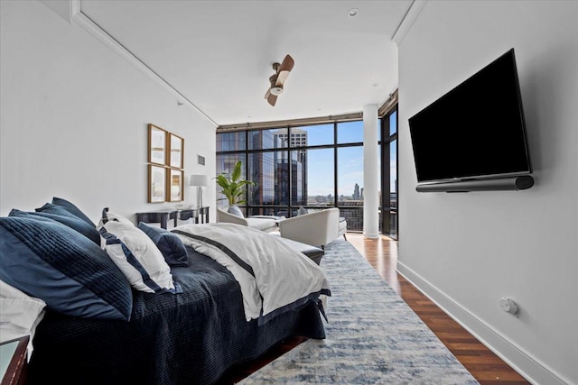 bedroom with expansive windows, baseboards, dark wood-style floors, and crown molding